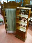 A vintage oak folding bookcase with brass rail and curtain to the front, 140 x 67 cms and a 1920's