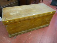 A Victorian pine lidded trunk with iron carrying handles, 46 x 106.5 cms