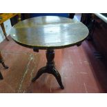 An antique oak circular top tripod table on a turned column support (feet reduced), 72 cms high,