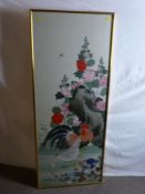An Oriental painted silkwork panel depicting a cockerel and hen with chicks before a floral