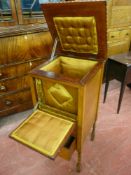 An early 20th Century mahogany work cabinet on barley twist supports, the lift-up rope patterned