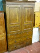 A Victorian scumbled pine press cupboard having two twin panelled doors with interior sliding
