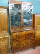 A William IV two piece mahogany bookcase secretaire having twin thirteen panel astragal glazed upper