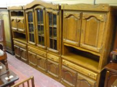 A 20th Century Dutch oak three part display unit of central arched top, triple glazed door display