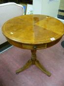 An early 19th Century drum type tripod table with circular segmented top and box wood line inlay,
