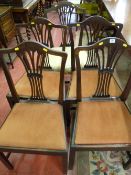 A set of four antique mahogany dining chairs with pierced splat backs and upholstered drop-in