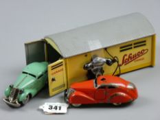 A Schuco garage no. 1500, yellow lithograph tinplate with grey roof and side telephone for automatic
