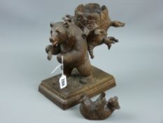 A Carved Black Forest bear carrying a basket on a stepped wooden base, 24 x 20 cms along with a