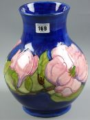 A Moorcroft Magnolia baluster form cobalt blue ground vase, 25 cms high, painted and impressed