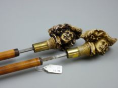 Two near square bladed bamboo sword sticks with resin cast heads of cavaliers forming the handles (