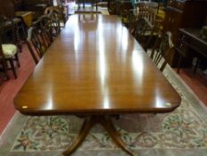 An excellent boardroom size table on turned column supports and four splayed reeded feet with