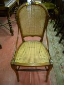 A circa 1900 mahogany hall chair with simple carved back decoration, cane seat and back and turned