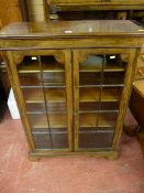 An early 20th Century mahogany two door bookcase with adjustable interior shelves on a bracket