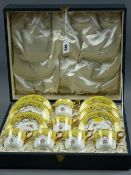 A cased set of six Coalport cups and saucers, yellow ground with gilt highlighting and handles and
