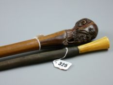 An African carved segmented cane with pipe smoking gent's head handle, 99 cms long and an African,