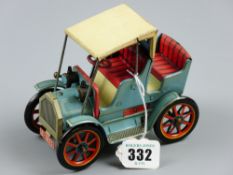 A lever driven tinplate model of a vintage car, blue, cream and red livery with spoke wheels, MT