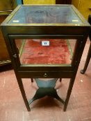 A 19th Century mahogany bijouterie cabinet with front opening door and drawer on square supports and