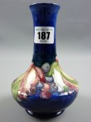 A Moorcroft Leaf & Berry cobalt ground narrow necked vase with flared body, 'Moorcroft' signature in