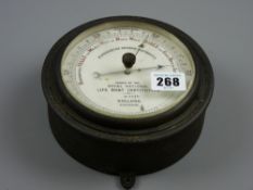 An RNLI fisherman's aneroid barometer marked 'Dollond, London', no. 2674, 16 cms diameter
