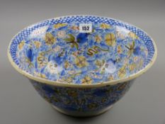 A large Continental faience polychrome decorated bowl, profuse overall decoration of blue, green,