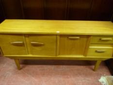 A light wood teak mid Century long sideboard with stylized wooden handles on tapering base supports,