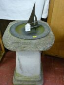 A reconstituted stoneware garden plinth with dished metal sundial/bird bath with yacht indicator,