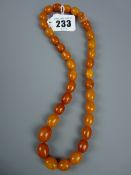 A graduated set of amber beads with screw-in clasp, 47 cms long, 30 grms gross