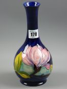 A Moorcroft Magnolia cobalt blue ground bottle vase with painted and impressed factory marks to