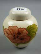 A Moorcroft Hibiscus cream ground ginger jar and cover, impressed 'Moorcroft, Made in England', 11