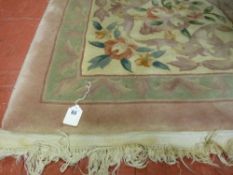 A Chinese washed woollen tasselled edge carpet, floral pattern on a pink ground, 8 ft x 10 ft