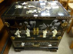 A 20th Century Oriental lacquerwork cabinet with two front opening doors and interior shelves and