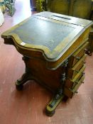 A 19th Century inlaid walnut Davenport, shaped tooled leather skiver to the sloping top, opening