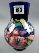 A Moorcroft Orchid cobalt blue ground bulbous vase, 17 cms high, Moorcroft signature and impressed
