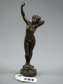 A small Vienna bronze figure of a nude female with outstretched arm on a circular base by Andor
