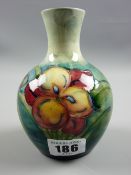 A Moorcroft Freesia on blue green ground vase, impressed factory marks to the base (crazing,