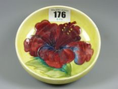 A Moorcroft Hibiscus yellow ground shallow footed bowl, impressed factory marks beneath, 11.5 cms