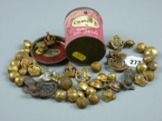 A Craven A Virginia cigarette tin containing a quantity of military cap badges, buttons and pip