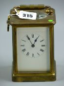 A heavy brass carriage clock, late 19th/early 20th Century, white dial with Roman numerals, triple