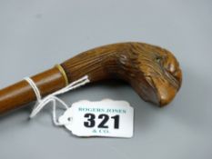 A slender walking cane with carved bird's head handle with yellow eyes and horn ring ferrule, 83