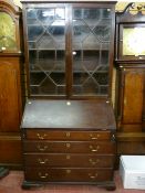 A late 18th Century mahogany bureau with a well fitted interior and four graduated oak lined drawers