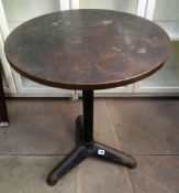 A copper top pub/industrial style table on painted metallic tripod supports