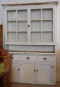 A large white painted dresser, the base with three cupboards below three equal upper drawers and