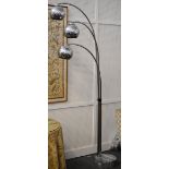 A designer chrome three branch standard lamp on a veined grey marble circular base