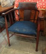 A vintage captain style elbow chair with padded and upholstered seat