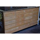 An excellent lightwood haberdashery chest of nineteen drawers with recess handles, 183cms