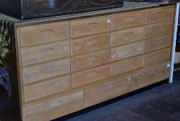 An excellent lightwood haberdashery chest of nineteen drawers with recess handles, 183cms