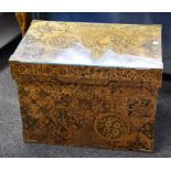 A vintage Japanese tea chest covered in decorative floral and geometric design paper