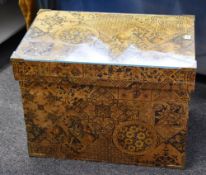 A vintage Japanese tea chest covered in decorative floral and geometric design paper