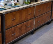 A four drawer department store cabinet composed of two pairs of side by side drawers with metallic