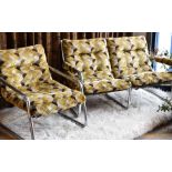 A 1970s stylish chrome two seater sofa and matching armchair in geometric velvet upholstery